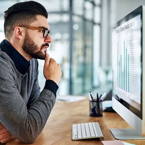 Younger man looking at a computer screen