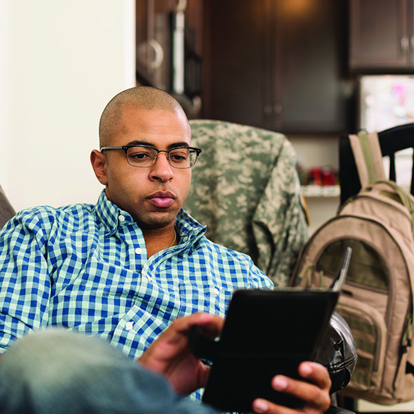 Military reservist looking at tablet