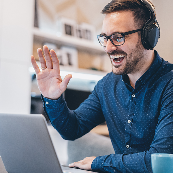 Man interacting in a virtual call on a laptop