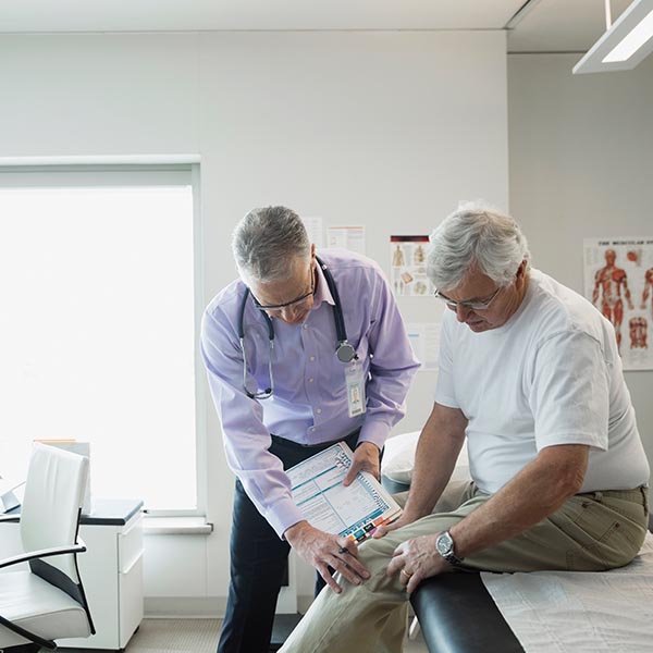 Doctor attending to elderly patient