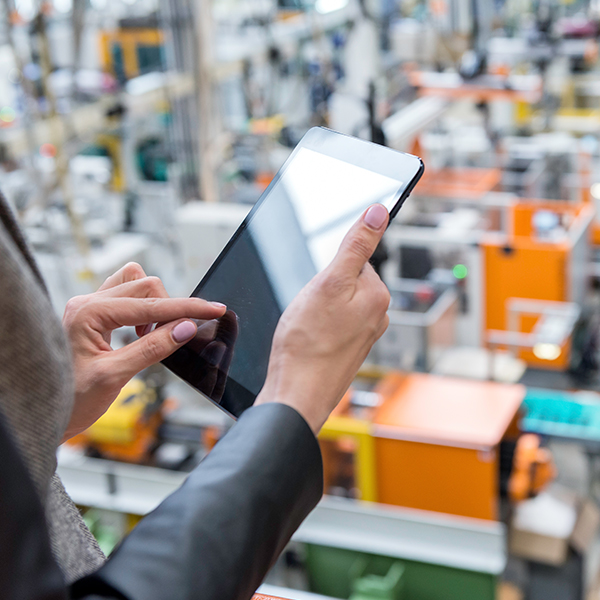 Taking inventory on iPad in manufacturing warehouse