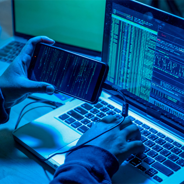 Hacker connecting phone and laptop