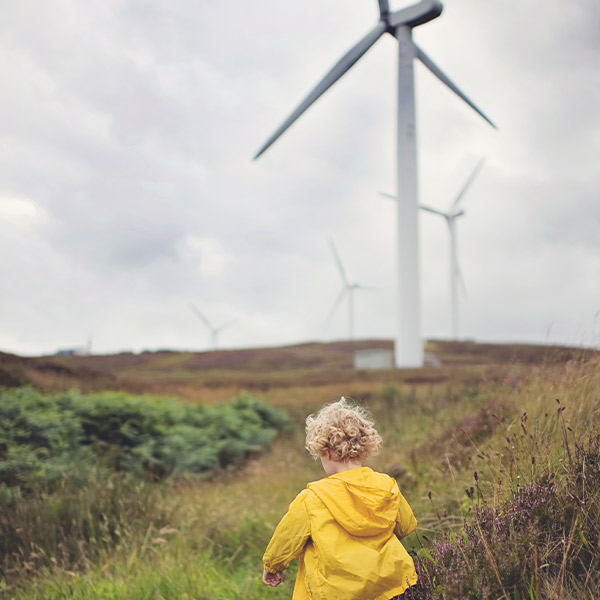 Child in front of wind turbine