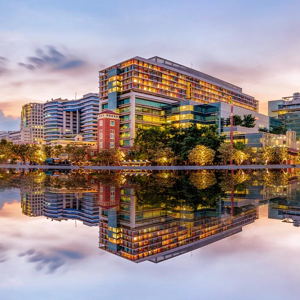 Hospital reflected in body of water