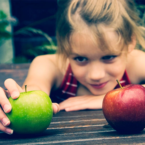 Girl with green and red apples