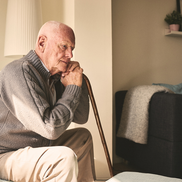 Elderly man holding cane
