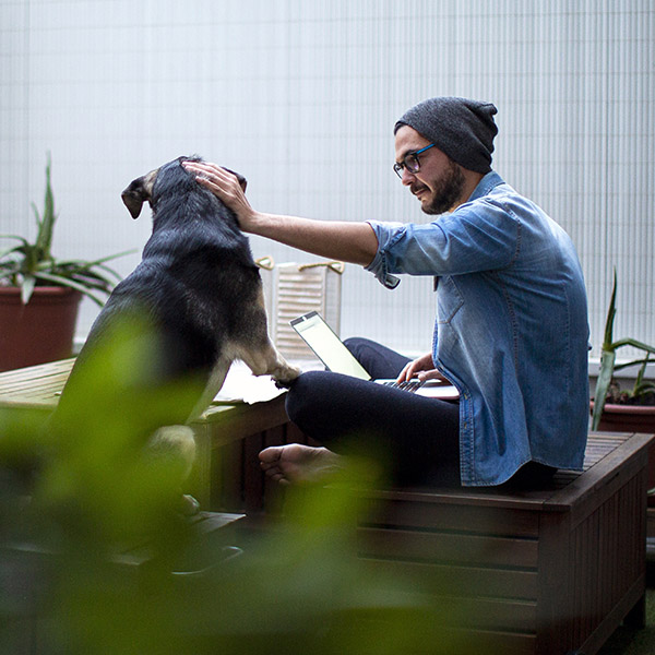 Man and dog on deck enjoying outdoors