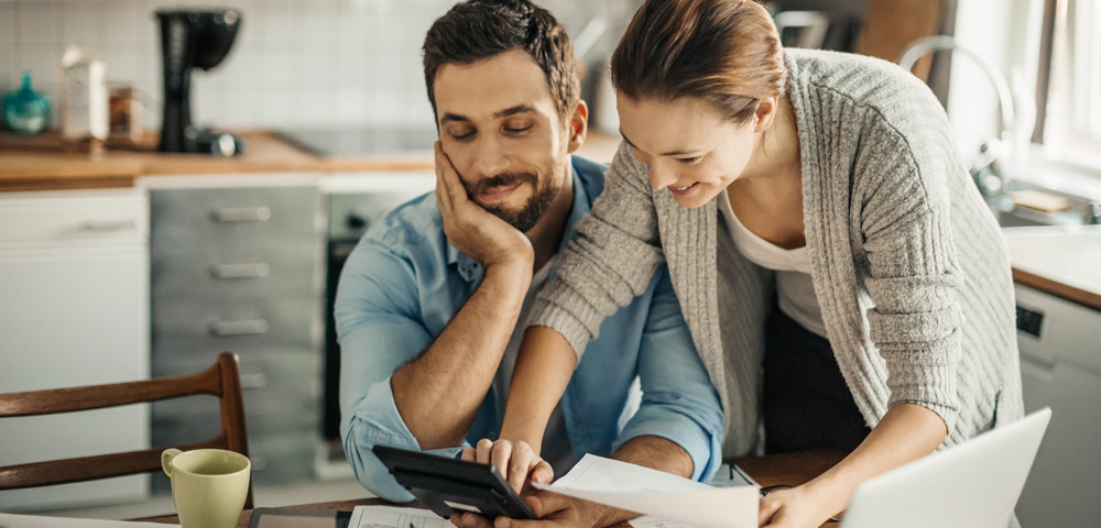 Man and woman using calculator