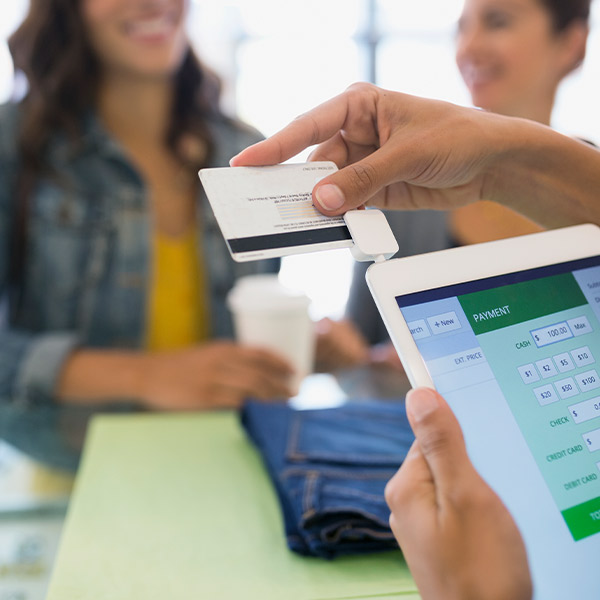 cashier swiping customer's credit card at a retail store