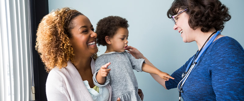 pediatrician with a child and her mother