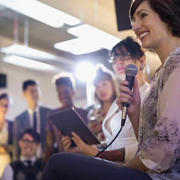 Woman holding a microphone at a conference