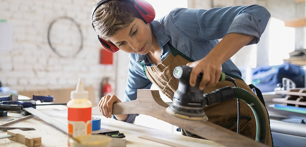Woman using a sander