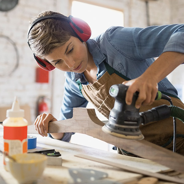 Woman using a sander