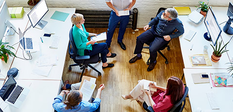 Business people sitting in chairs talking