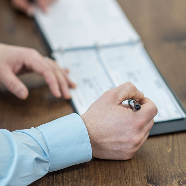 man with a checkbook writing a check