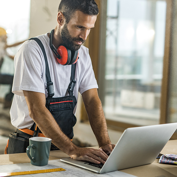 Male contractor using laptop