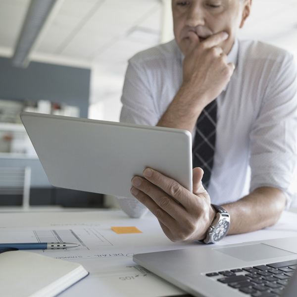 man looking at a tablet
