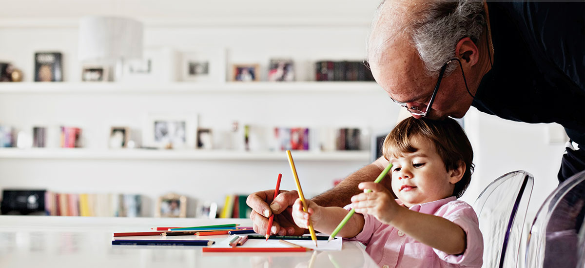 Grandfather and grandchild drawing together
